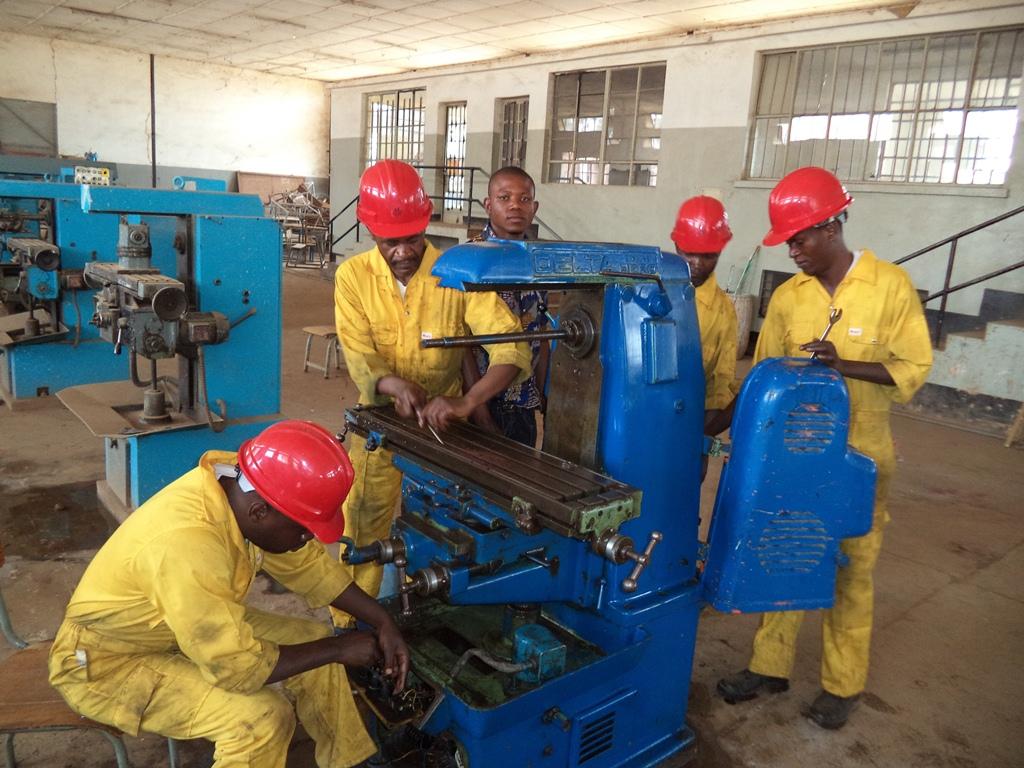 Workers around blue machine